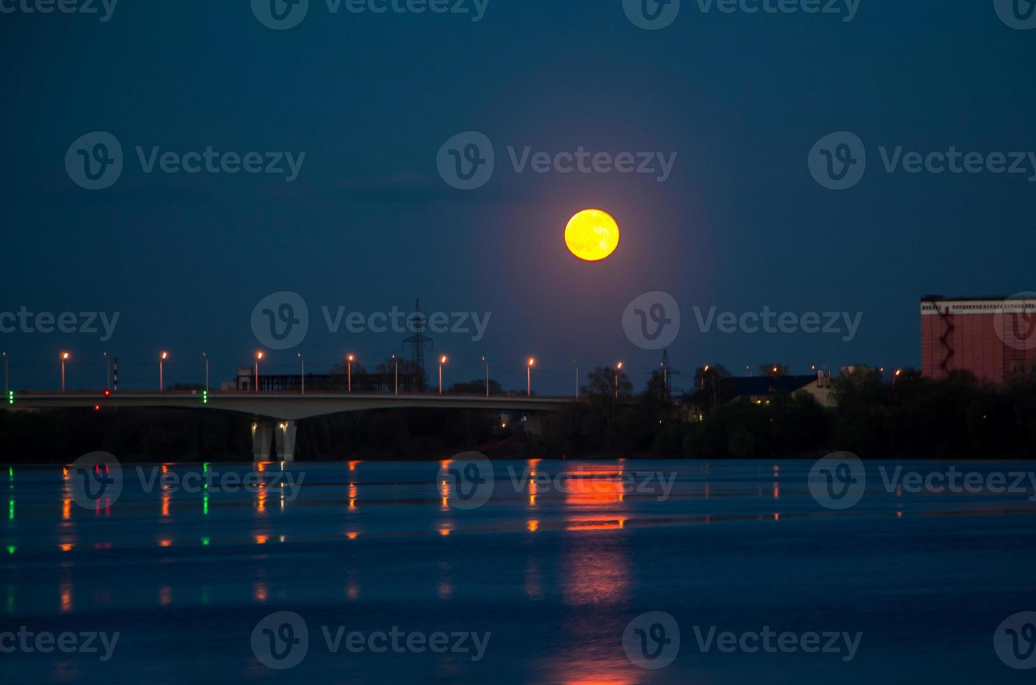 The red moon is reflected in the water photo