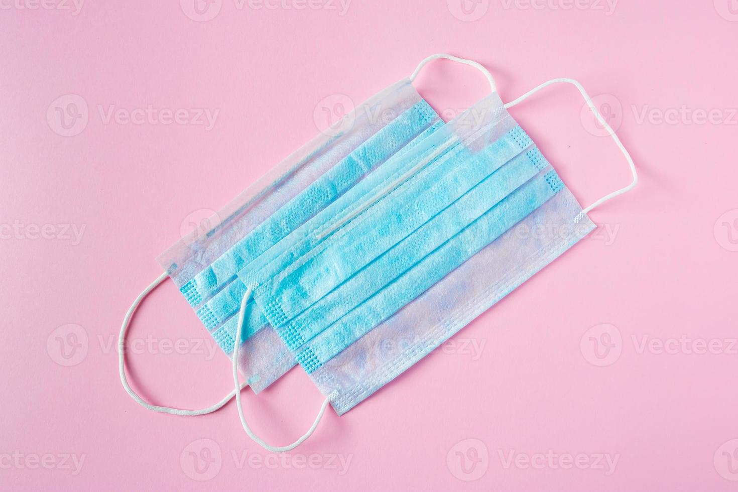 Medical face mask on a pink background. Preventive protection against coronavirus. photo