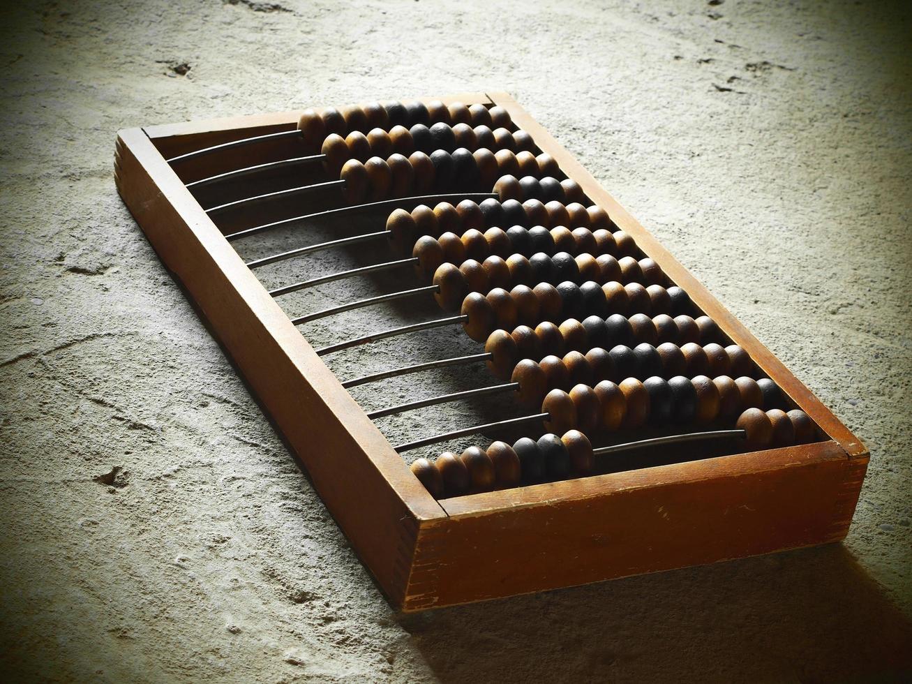 Old wooden abacus on a concrete surface photo