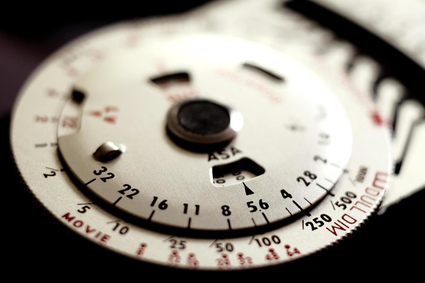 Vintage analog photographic light meter with rotary dials. photo