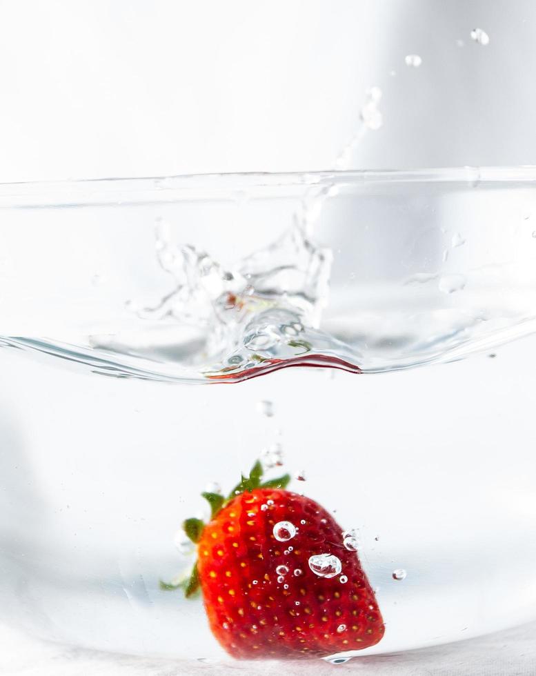 Strawberry in a bowl of water photo