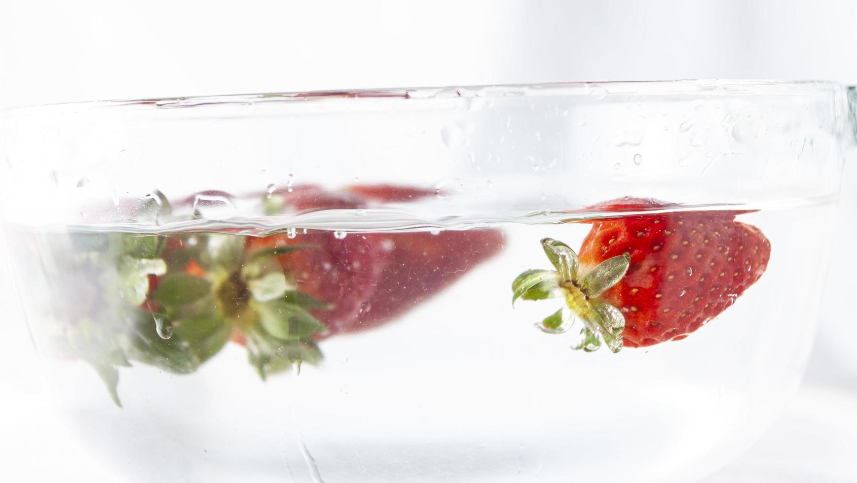 Strawberries in a bowl of water photo