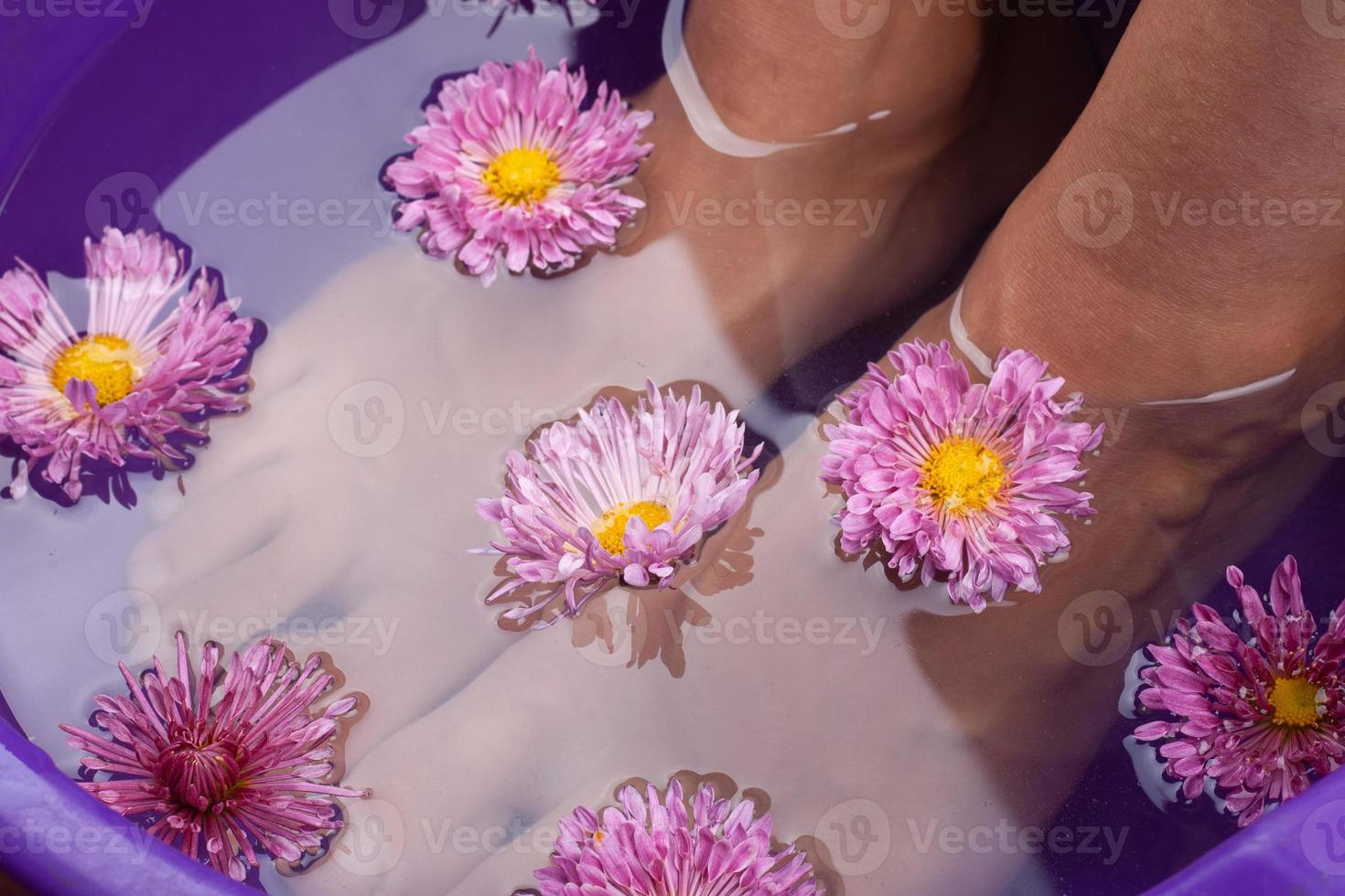 Baño de pies aromático con flores de cerca foto