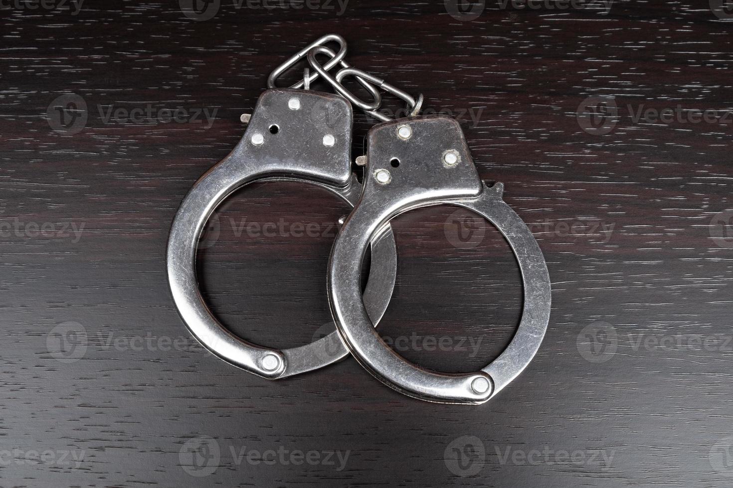 Handcuffs on the table, arrest imprisonment. photo
