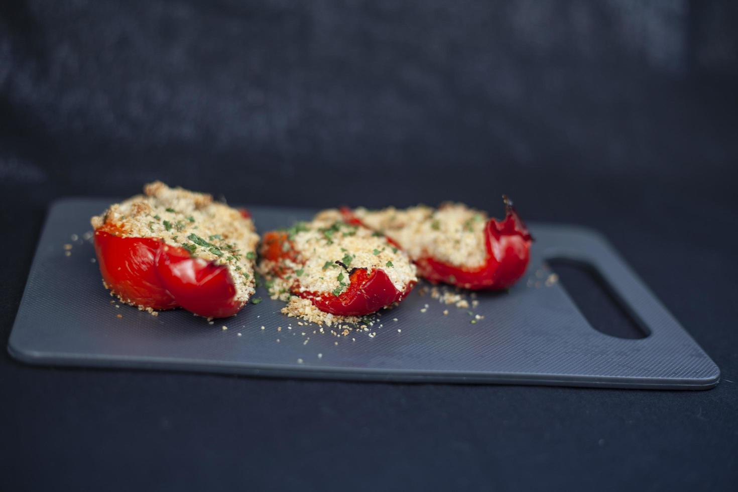 Stuffed bell peppers on a cutting board photo