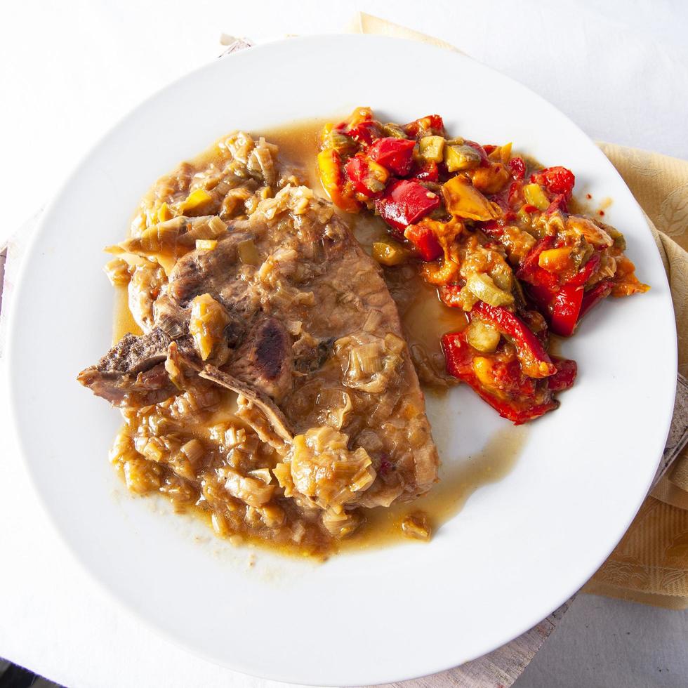 Top view of pork chops with vegetables. photo