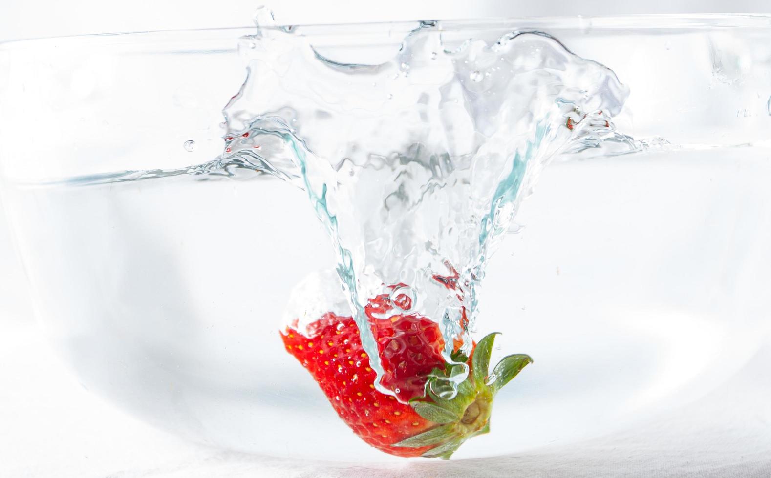 Strawberry thrown in water photo