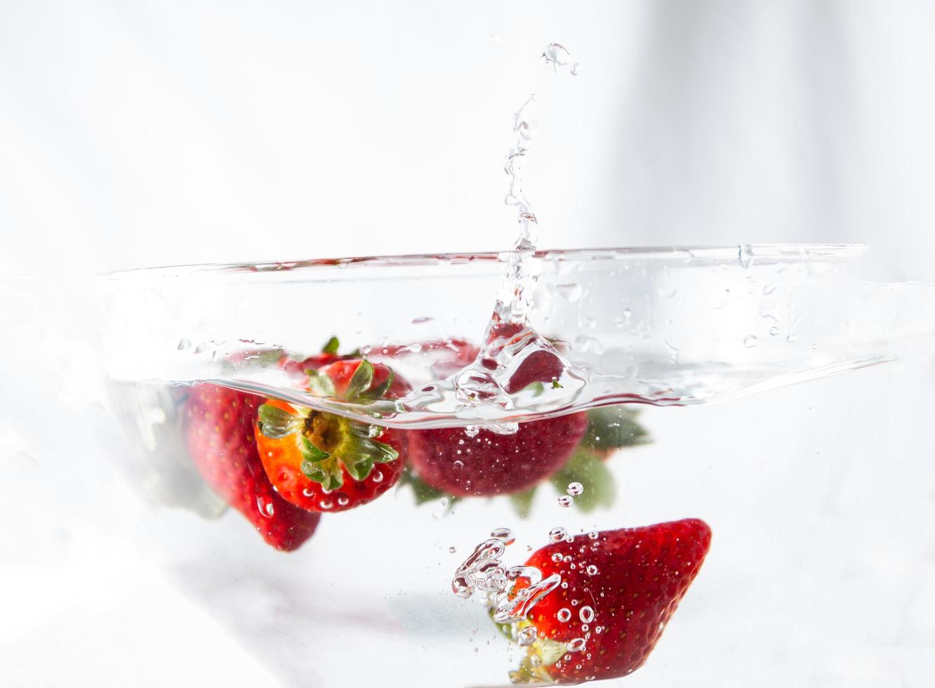 Strawberries in water bowl photo