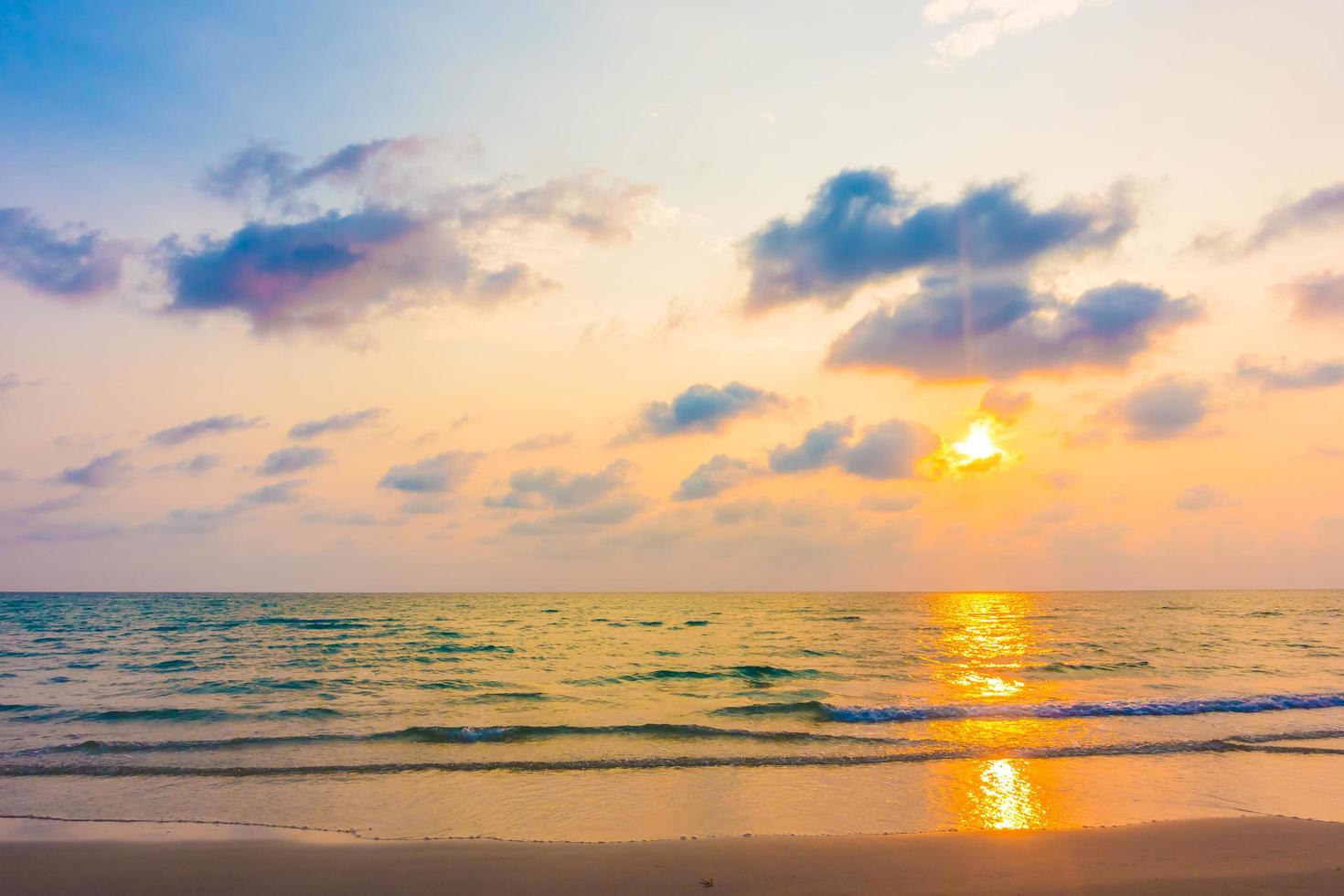 Sunset with sea on the beach photo