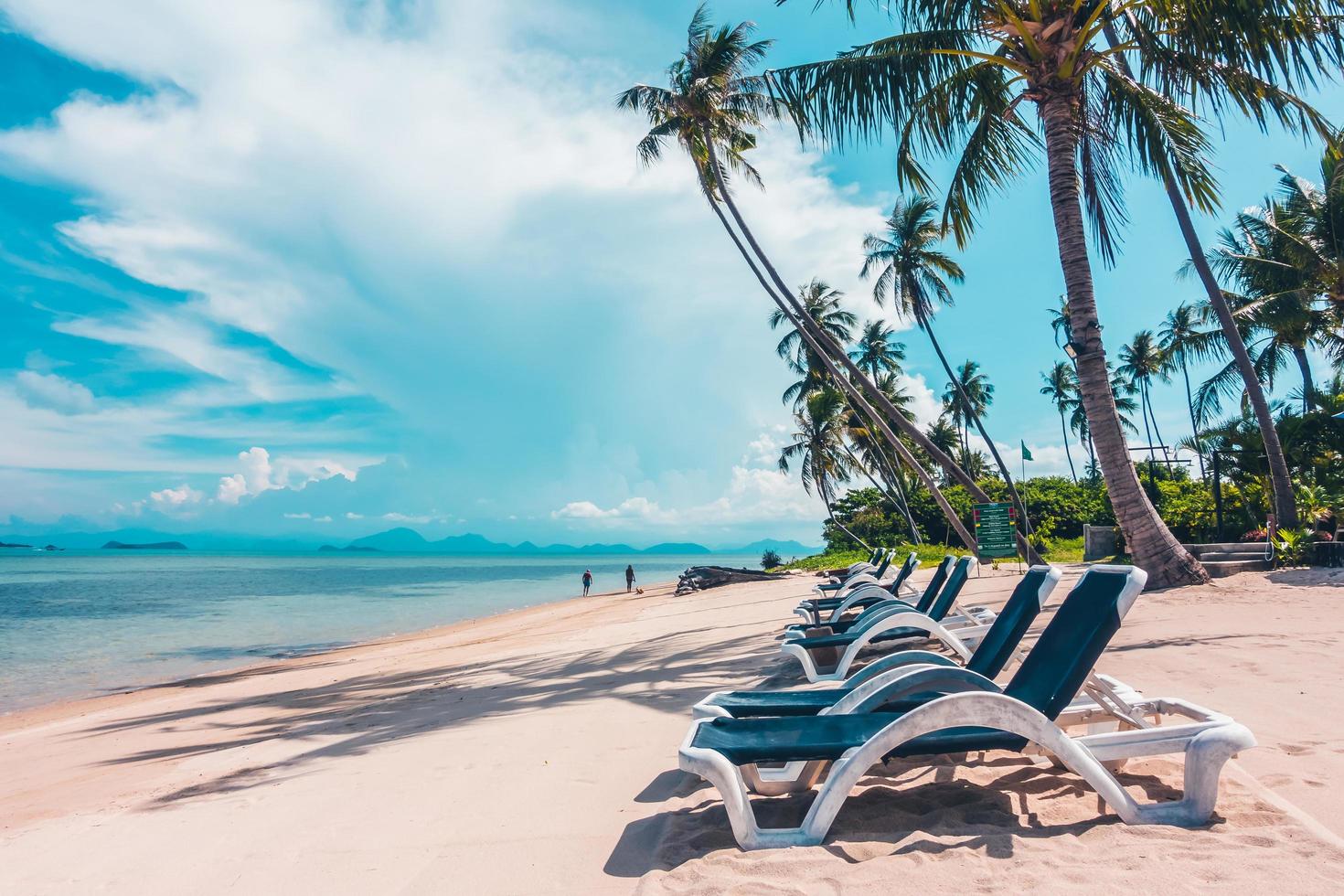 Beautiful outdoor view with sunbathing beds on the beach photo