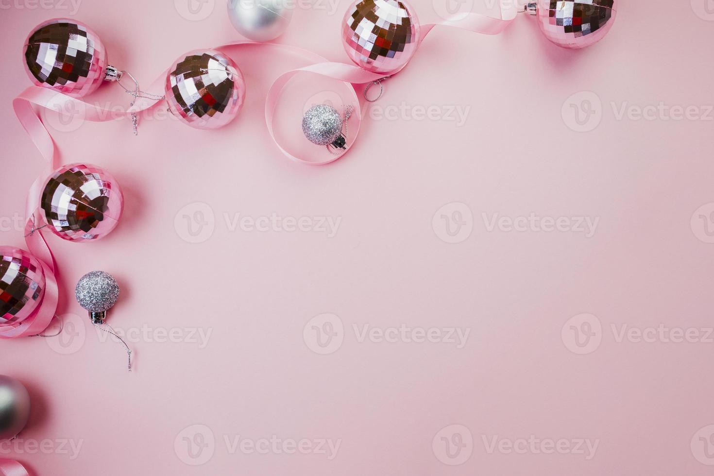 Bright baubles on pink background photo