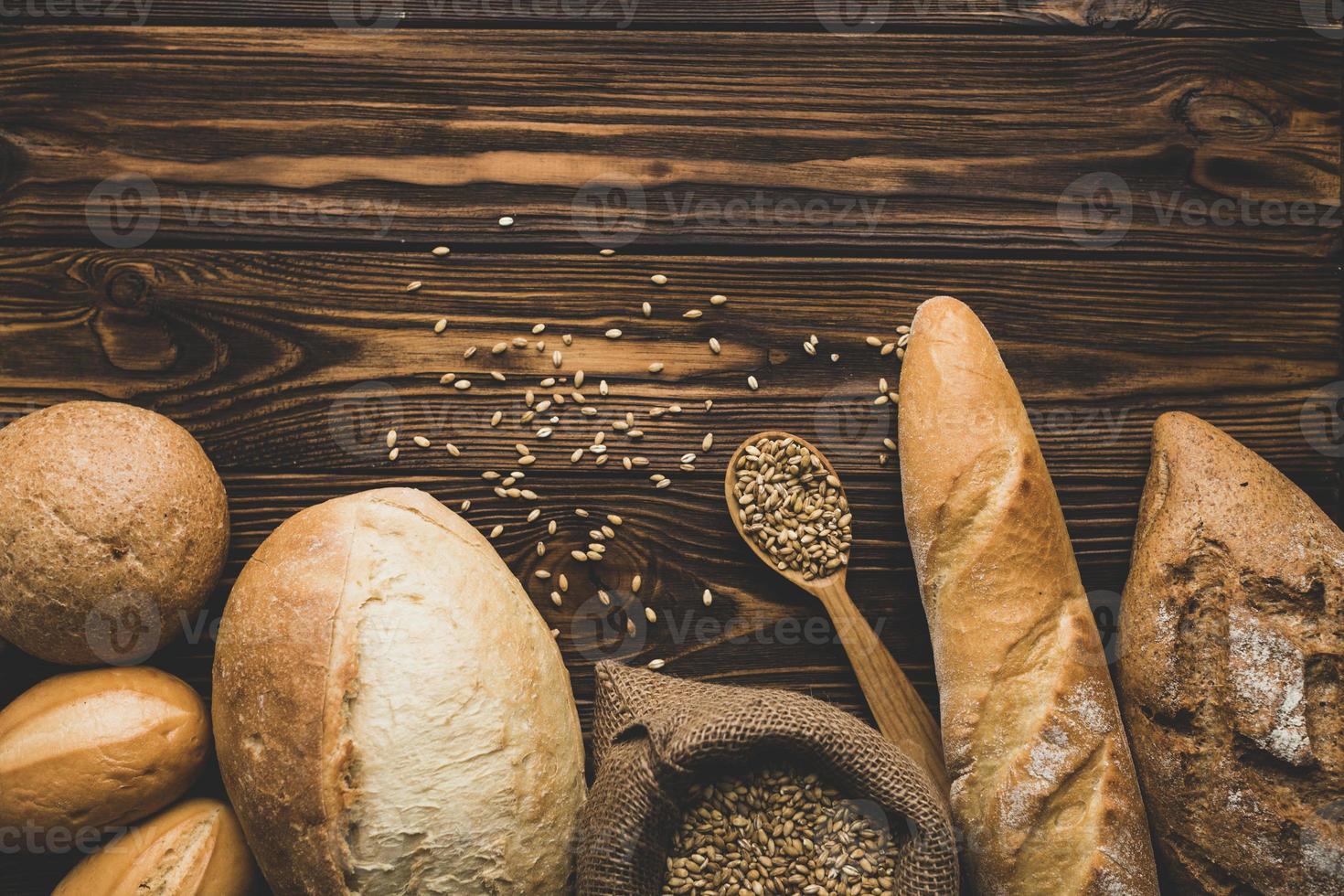 Assortment of bread loaves on wood background photo