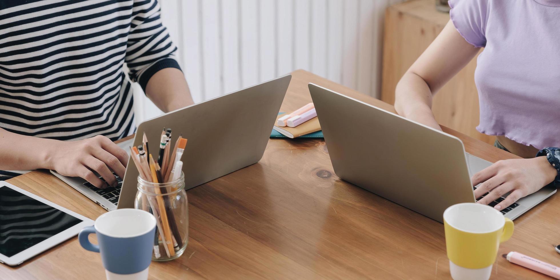 Two people working on a table photo