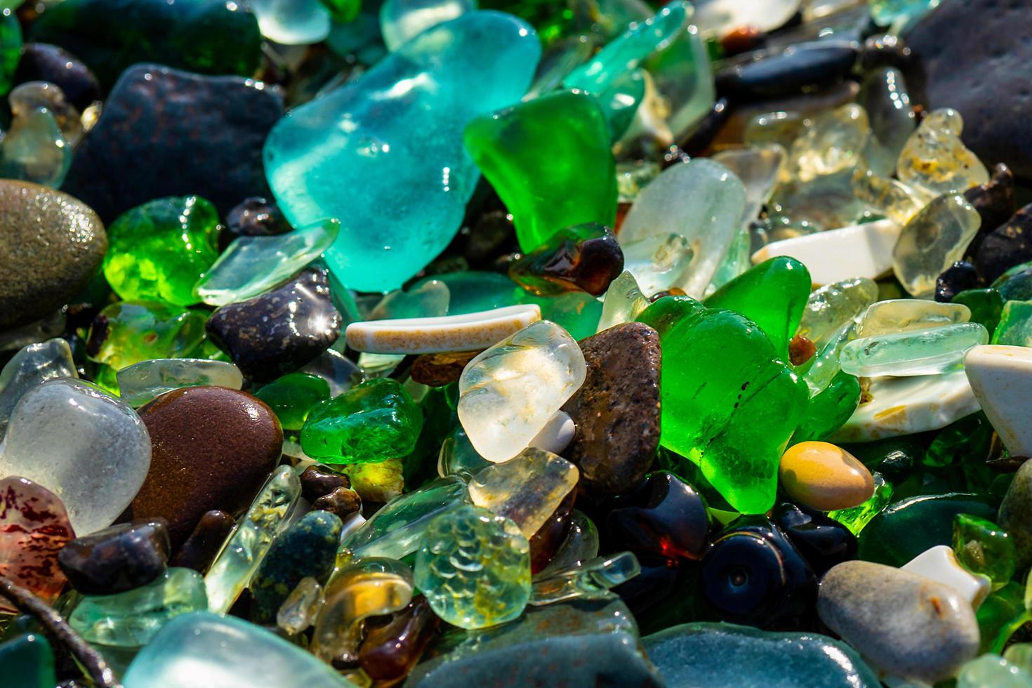 Close-up of colorful sea glass on sand in Vladivostok, Russia photo