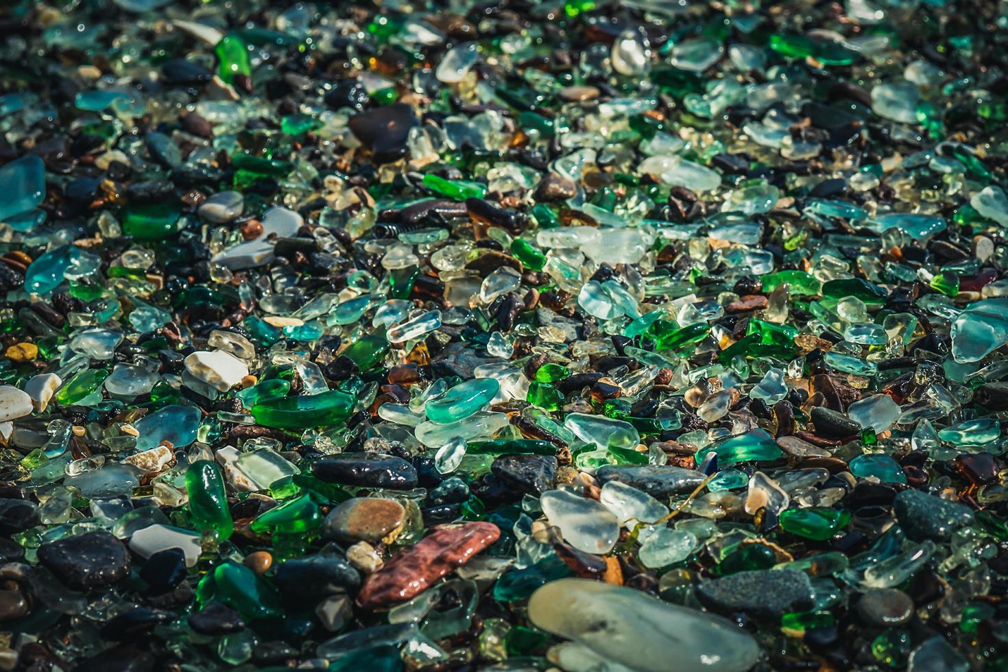 Close-up of colorful sea glass on sand in Vladivostok, Russia photo