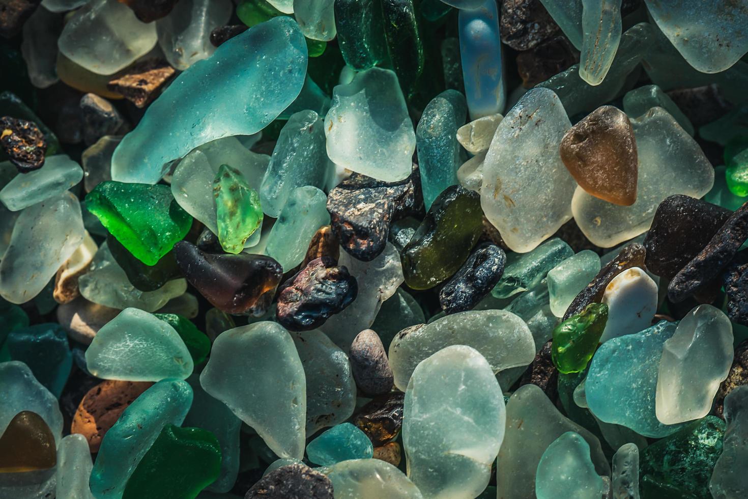 Close-up of colorful sea glass on sand in Vladivostok, Russia photo