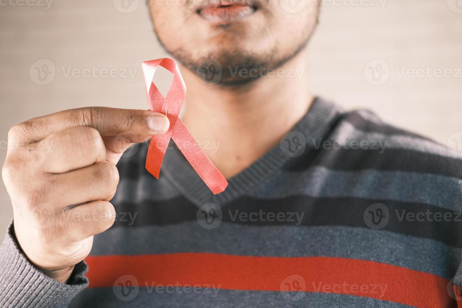 Man holding a red ribbon photo