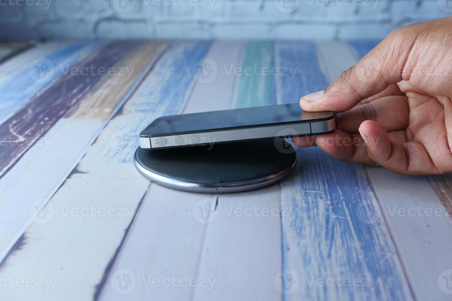 Man charging his phone photo