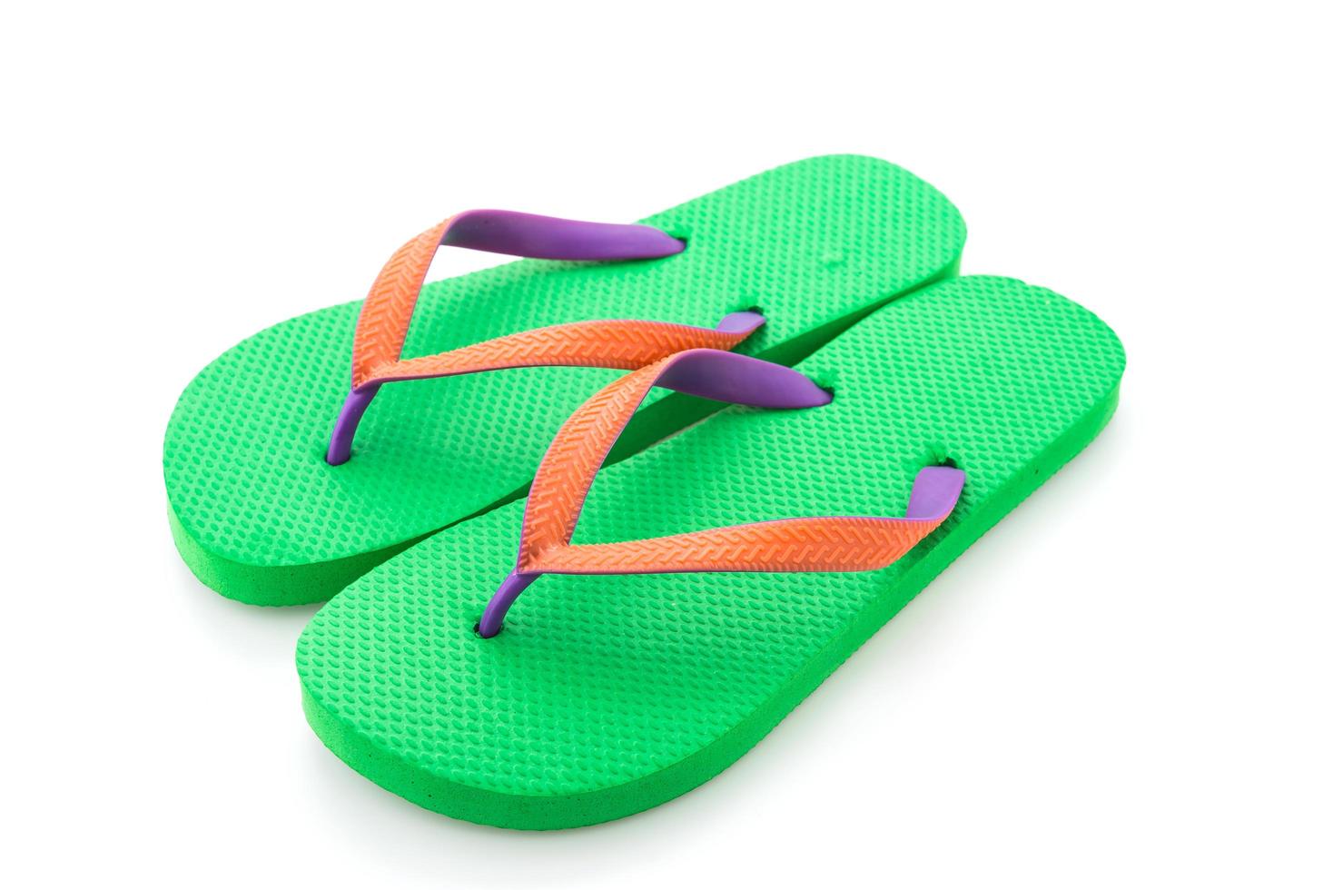 Green flip flop isolated on white background photo