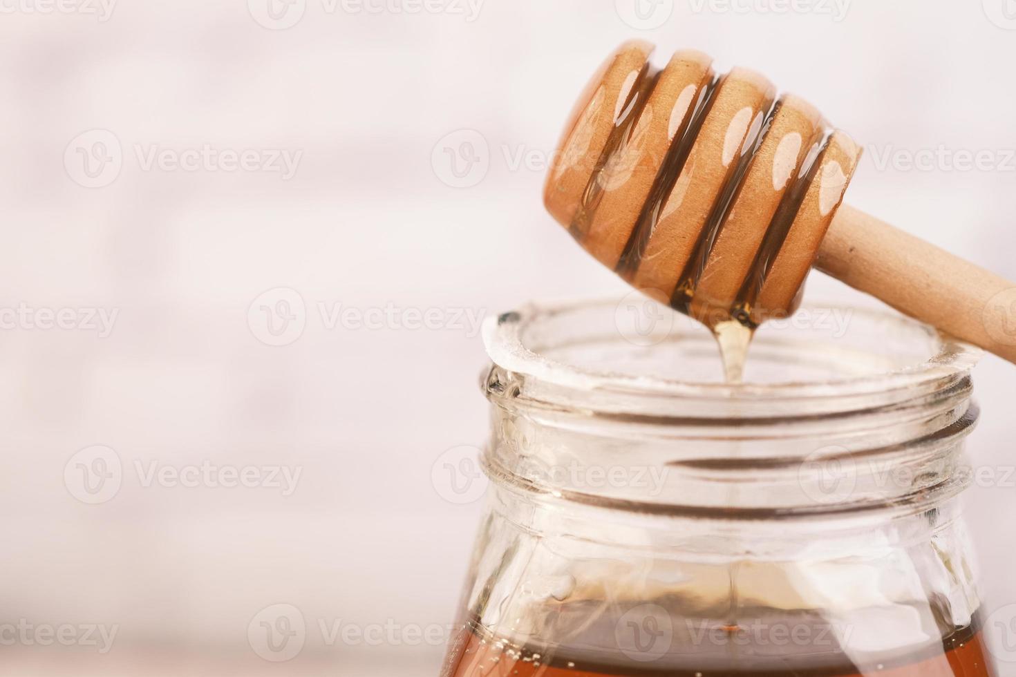 Honey dipper and honey photo