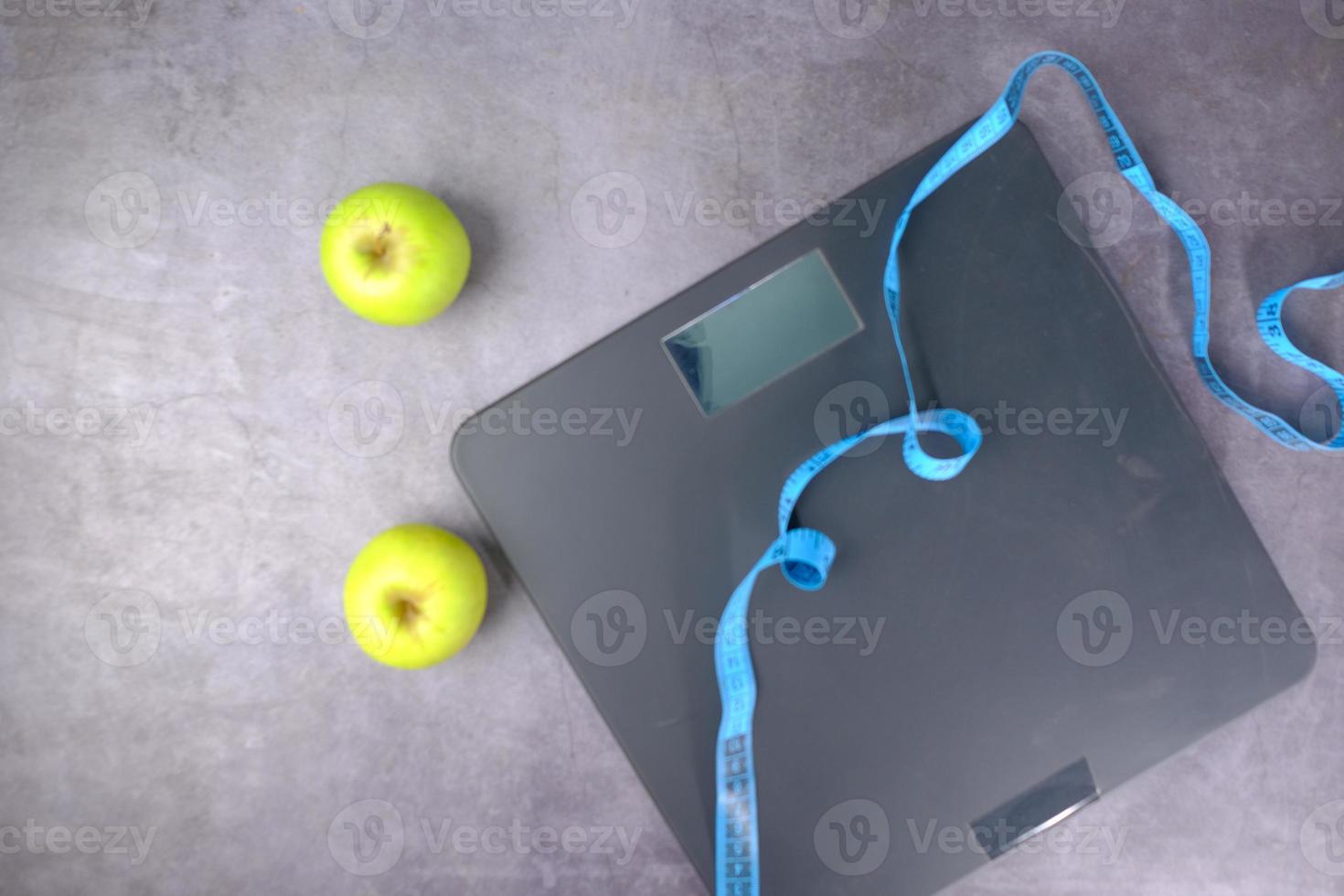 Apples with a measuring tape and scale photo