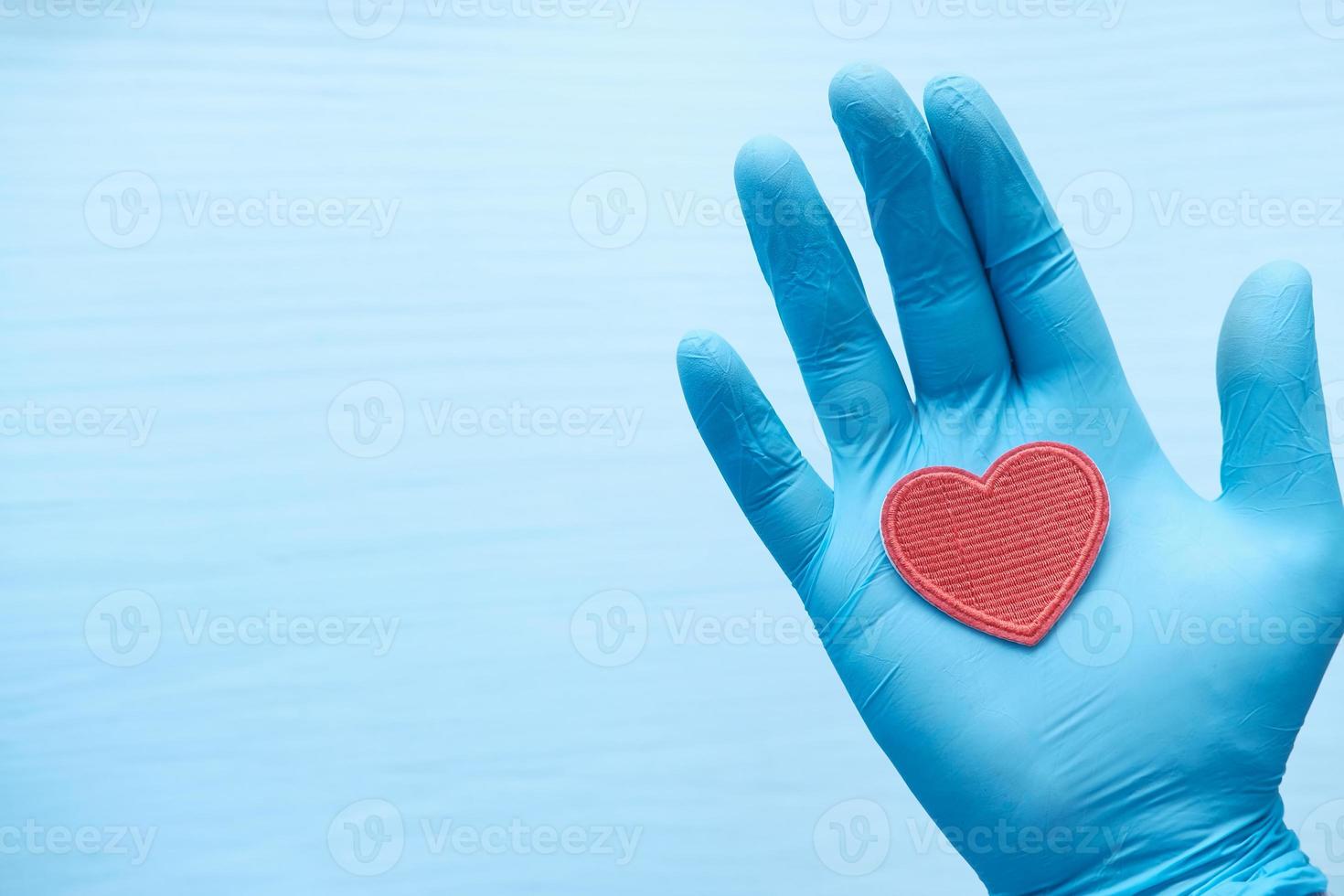 Red heart in gloved hand photo