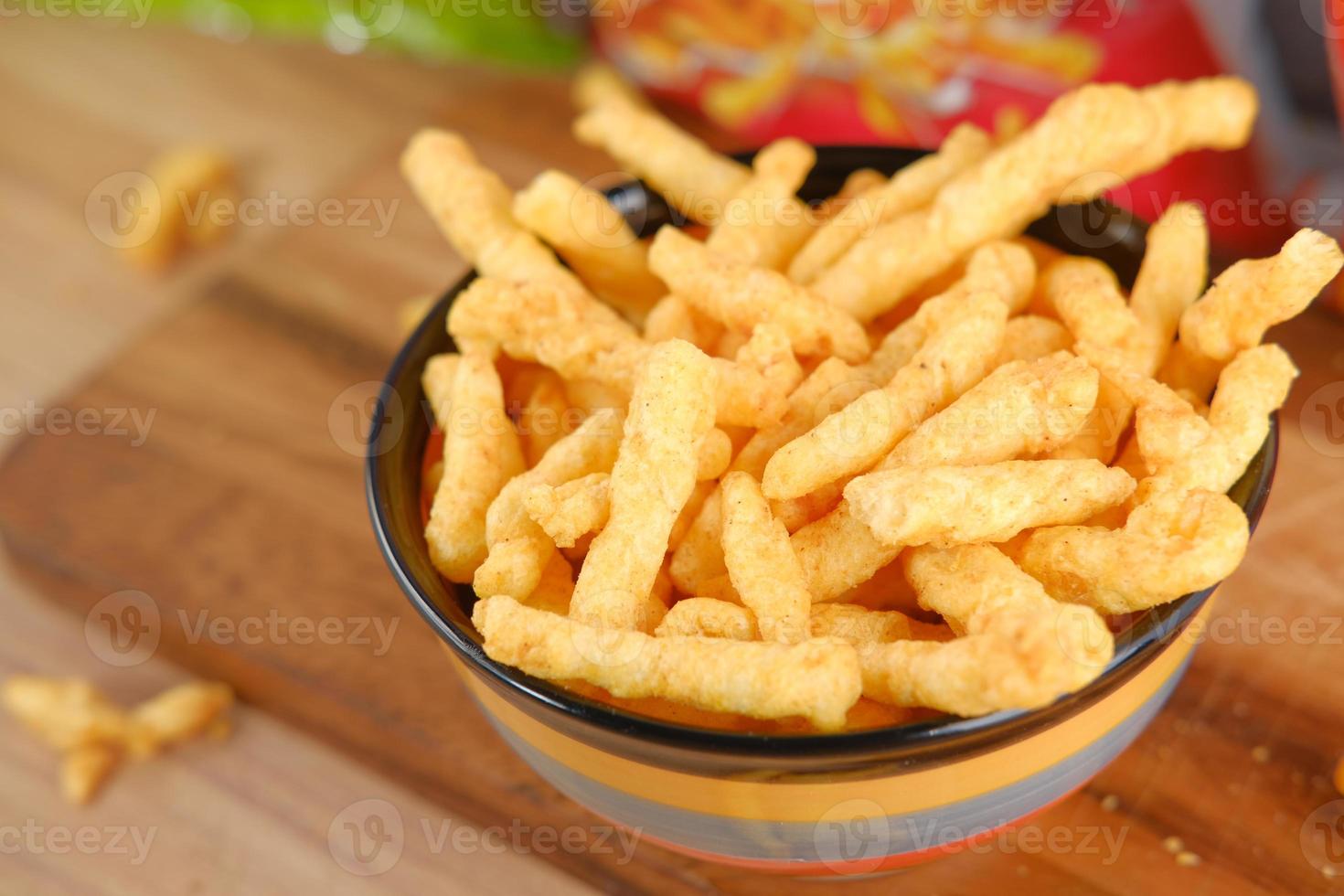 Bowl with tasty potato chips photo