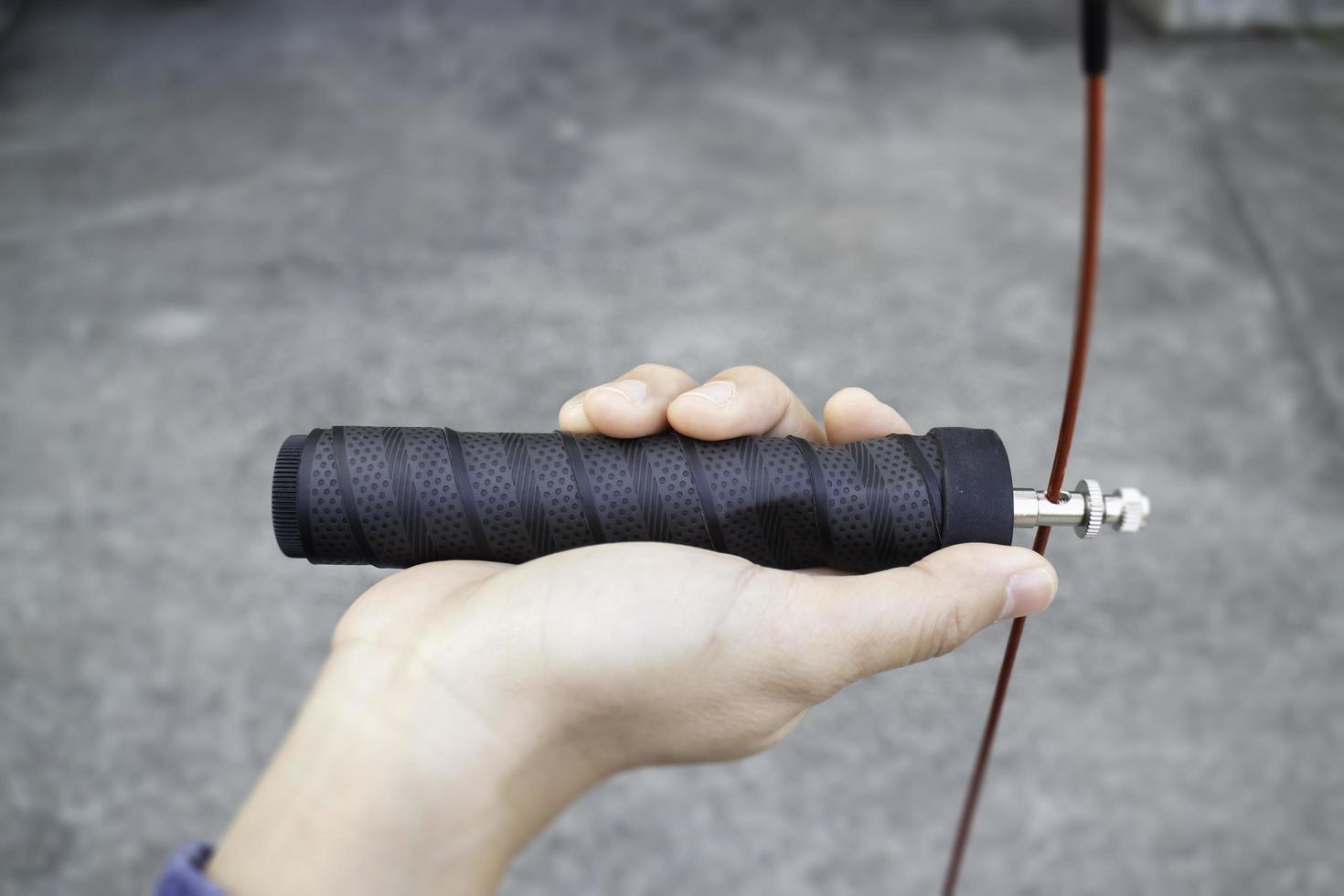 Hand of woman holding a speed jump rope photo