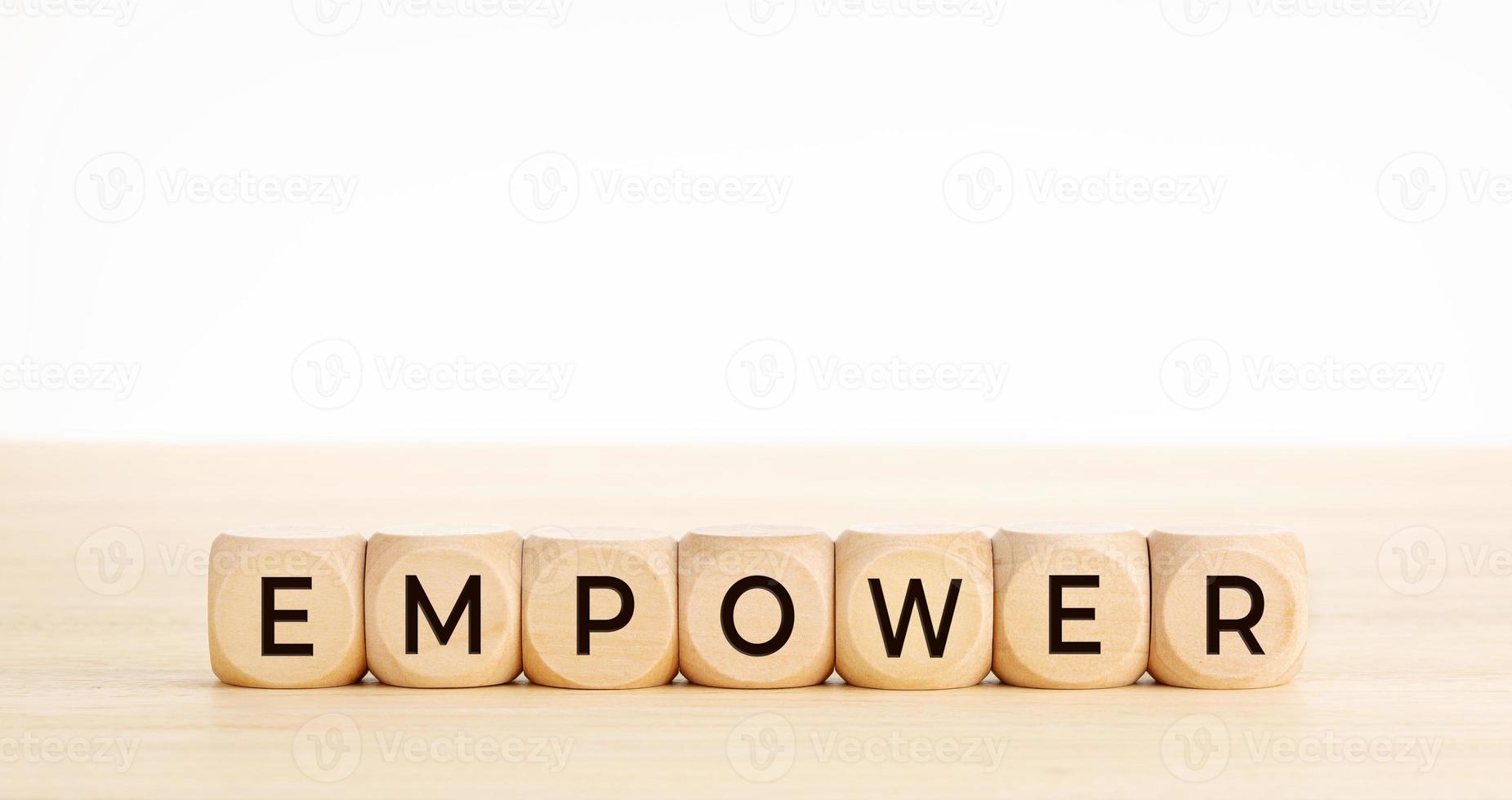EMPOWER word on wooden blocks on wood table photo