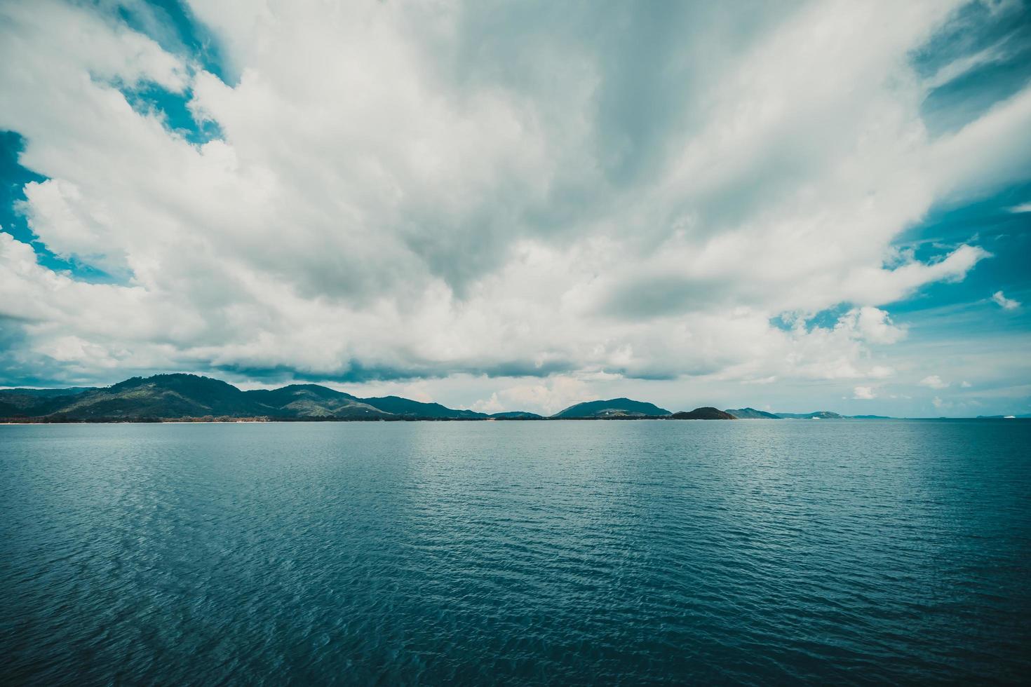 Dark clouds on sky with island photo