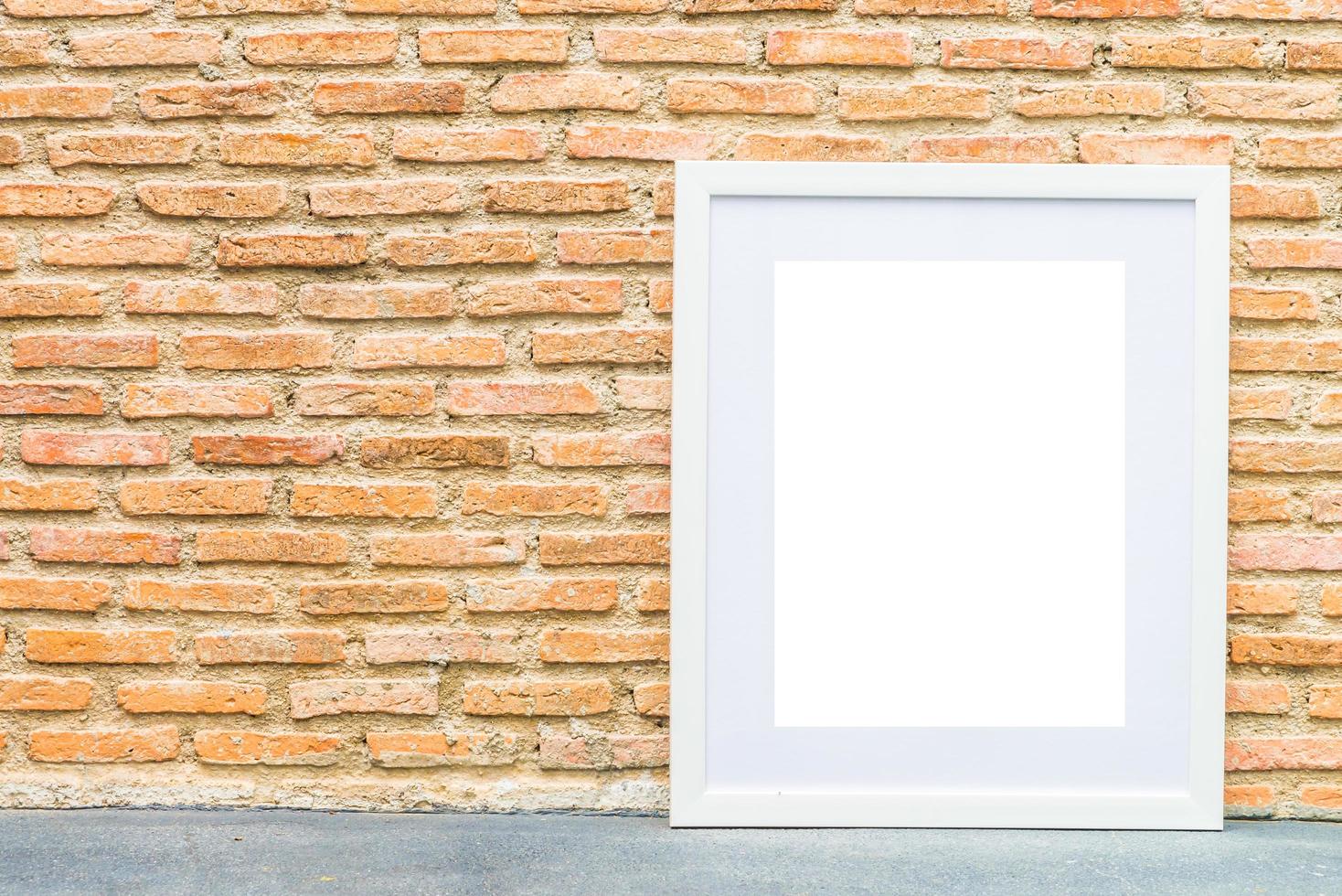 Blank frame on brick wall background photo