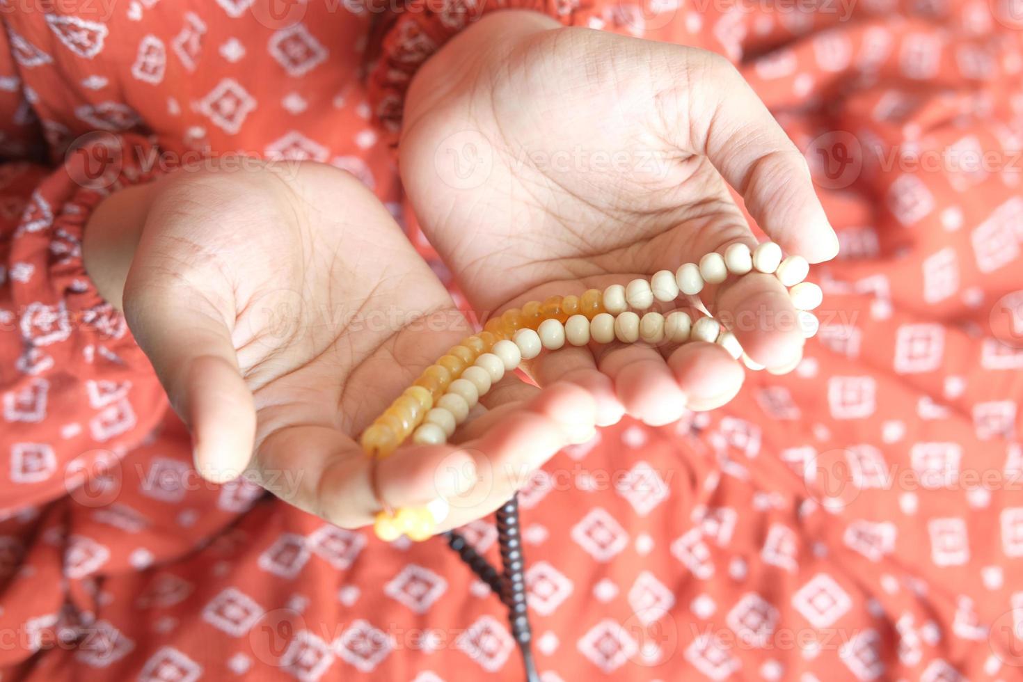 Women holding prayer beads photo