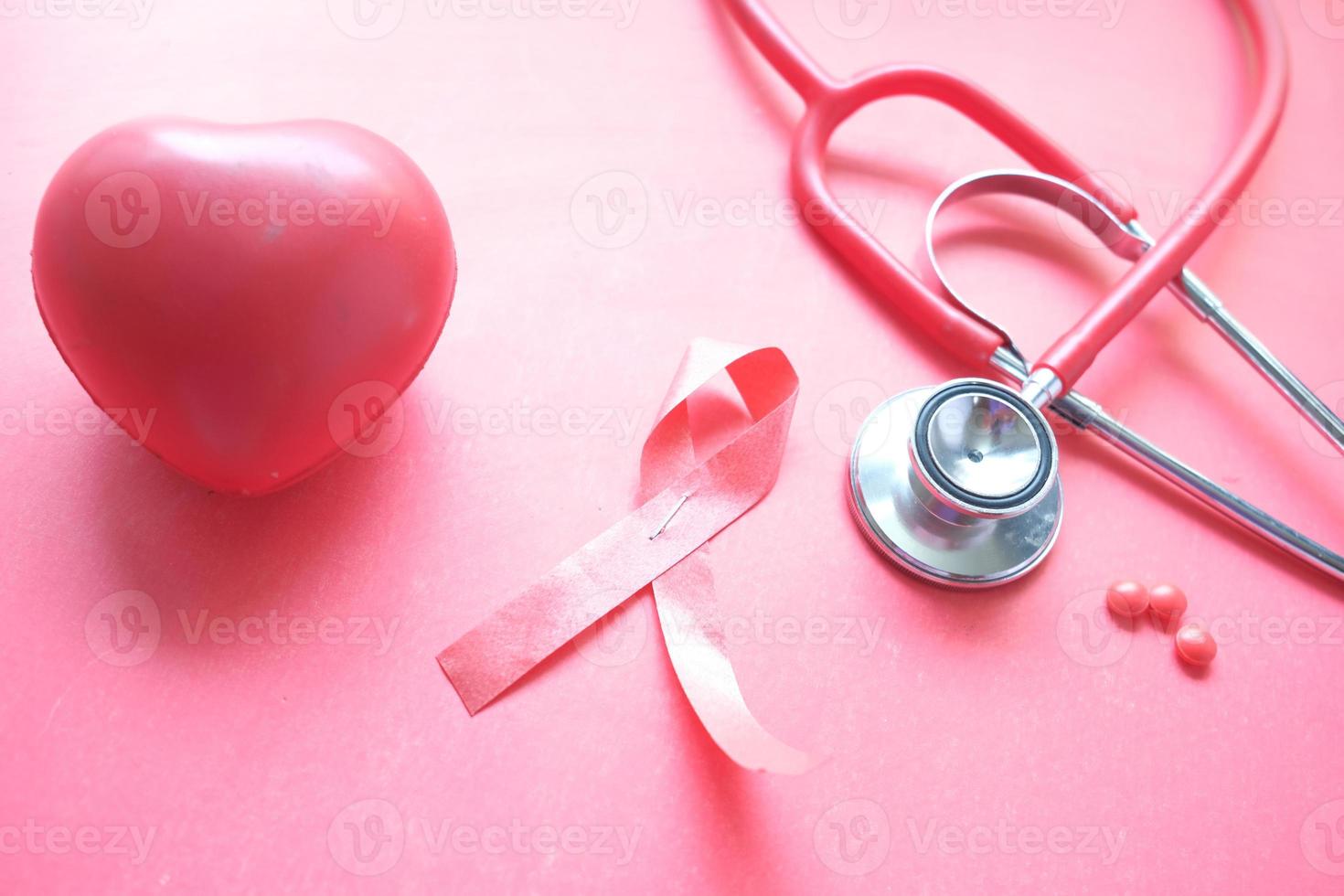 Pink ribbon with heart and stethoscope photo