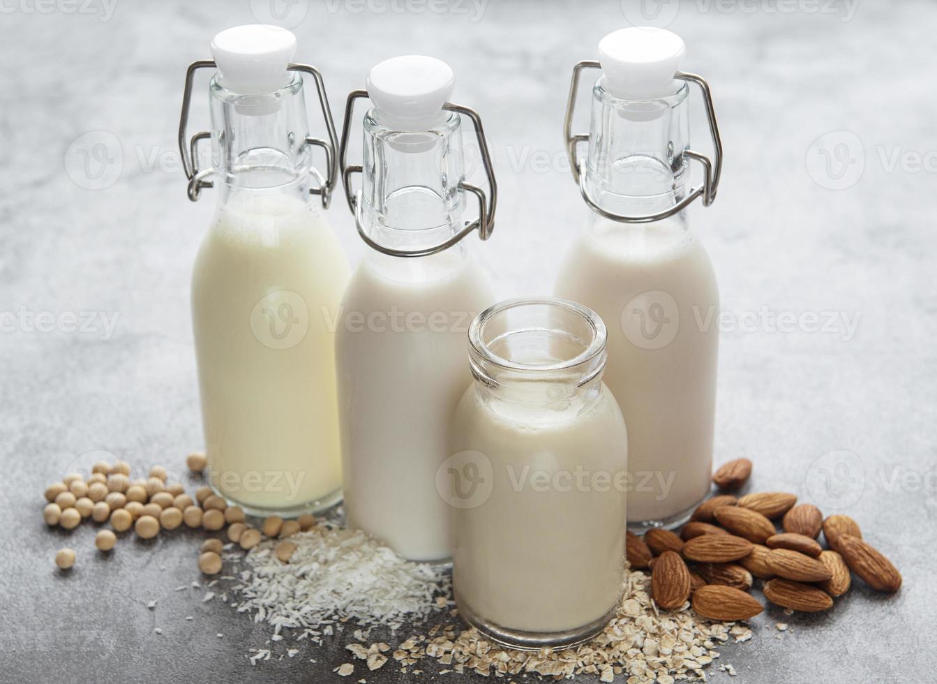 Bottles with different vegetable milk photo