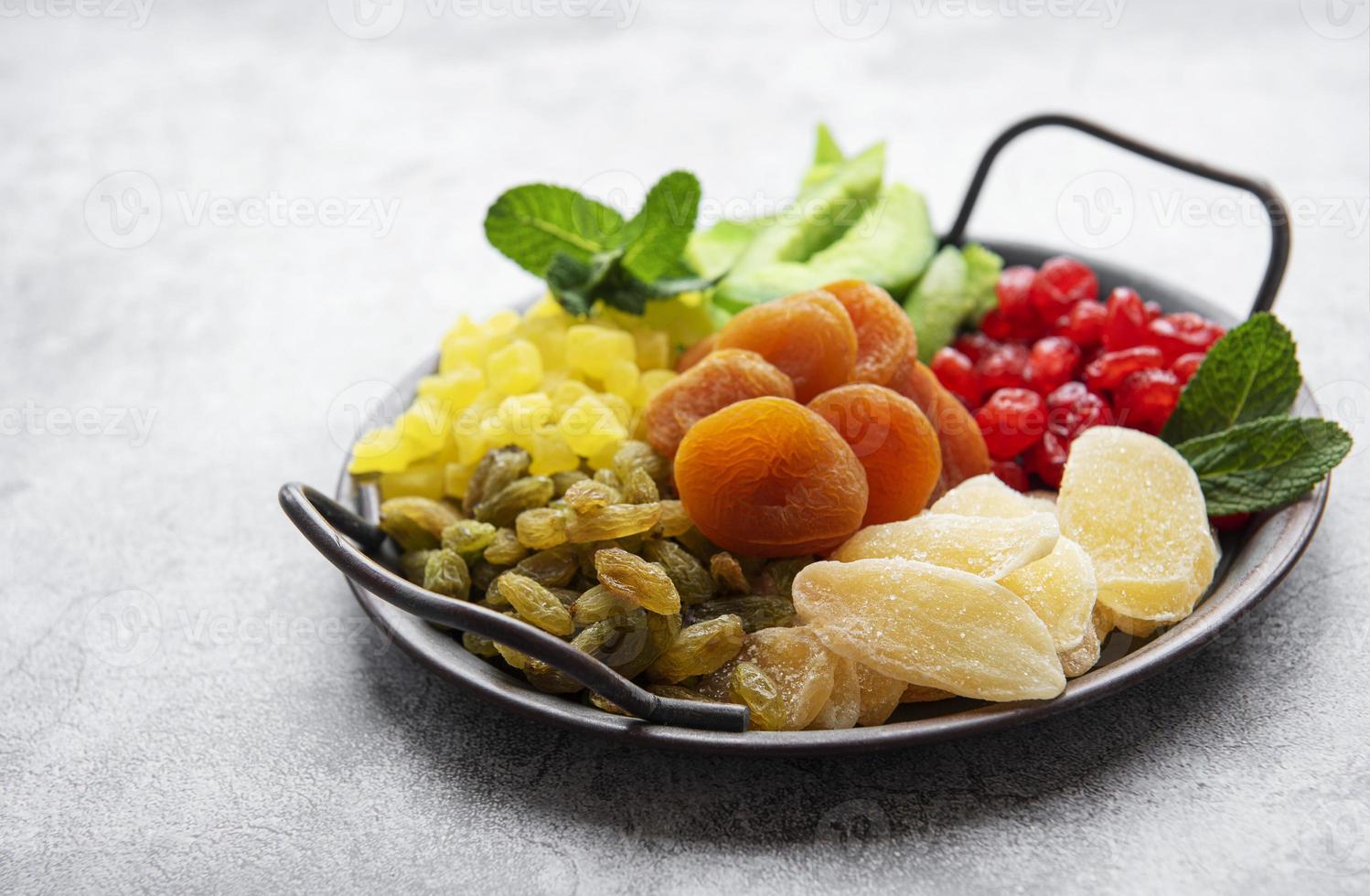 Metal tray with different types of dried fruits photo