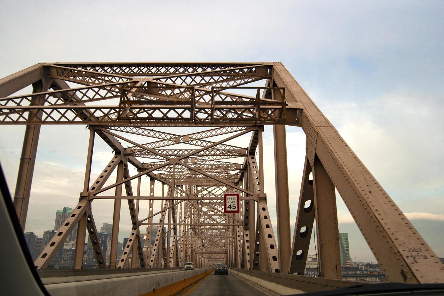 Cars driving on an old metal bridge photo