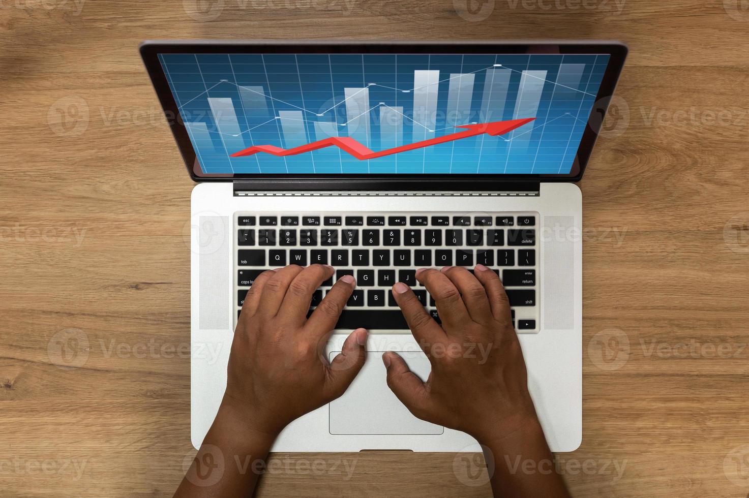 Top view of bar graphs on a computer screen with hands photo