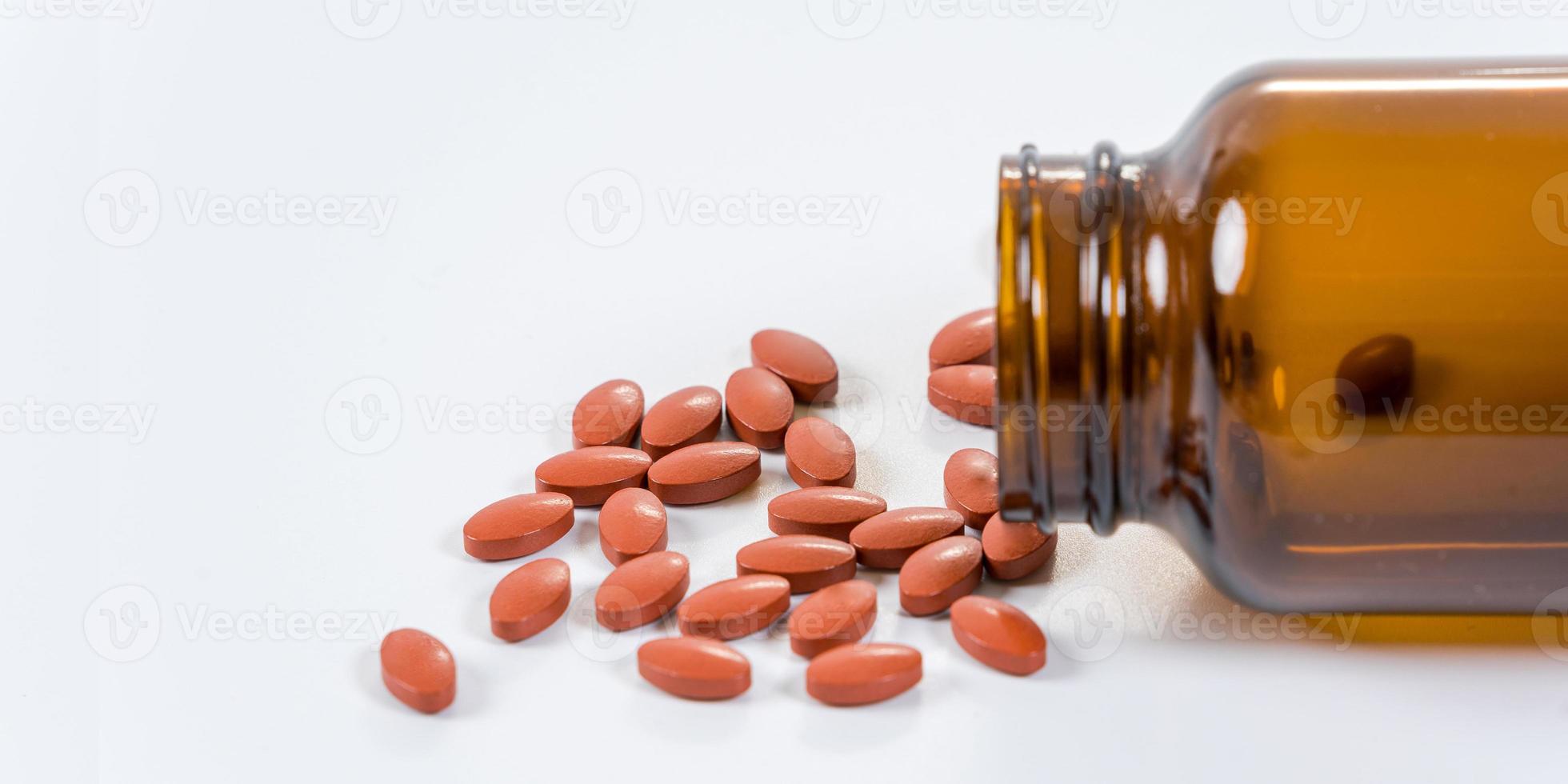 A lot of pills and medicine pouring from the bottle on white background photo