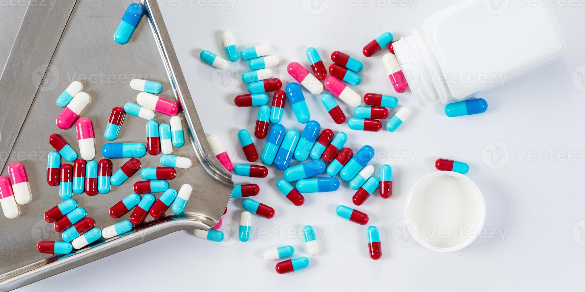 Many type of medical drugs pills capsules on white background photo