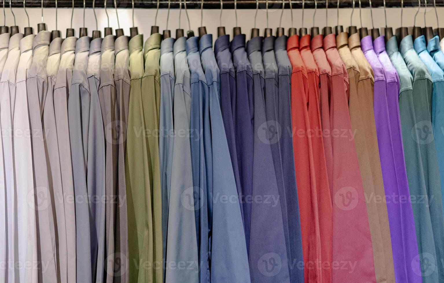 Close up of multi colored shirts on hangers photo