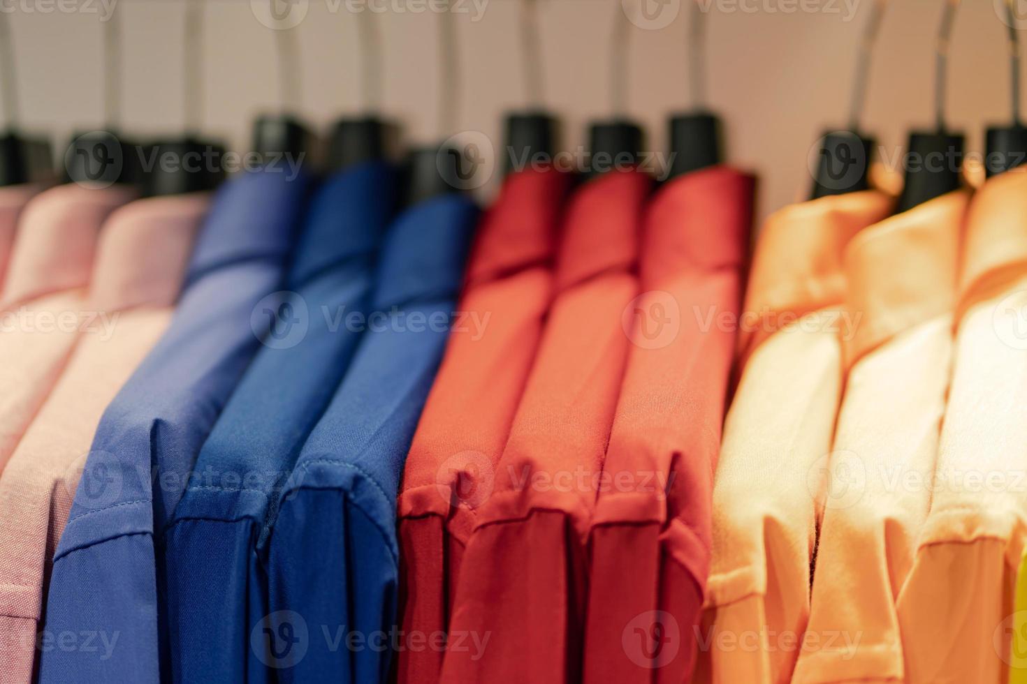 Close up of multi colored shirts on hangers photo