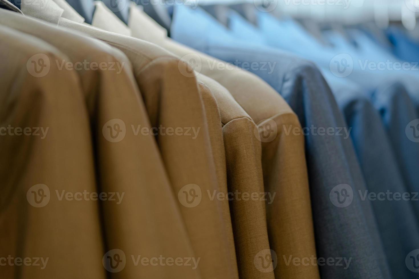 Close up of luxurious style gentlemen suit on hangers photo