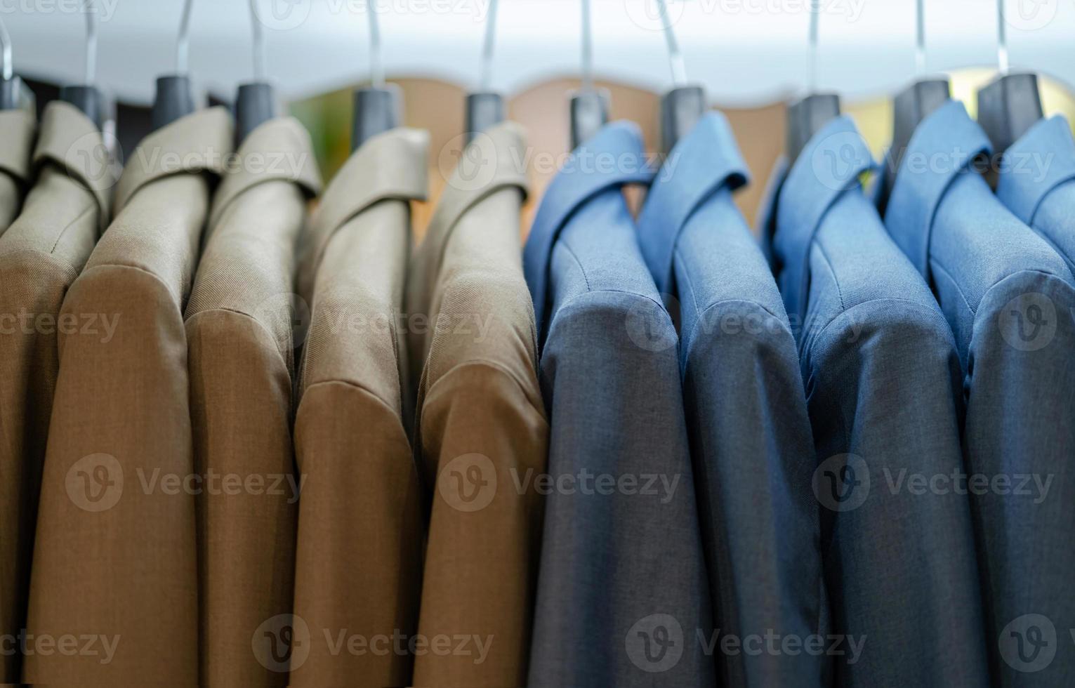 Close up of luxurious style gentlemen suit on hangers photo