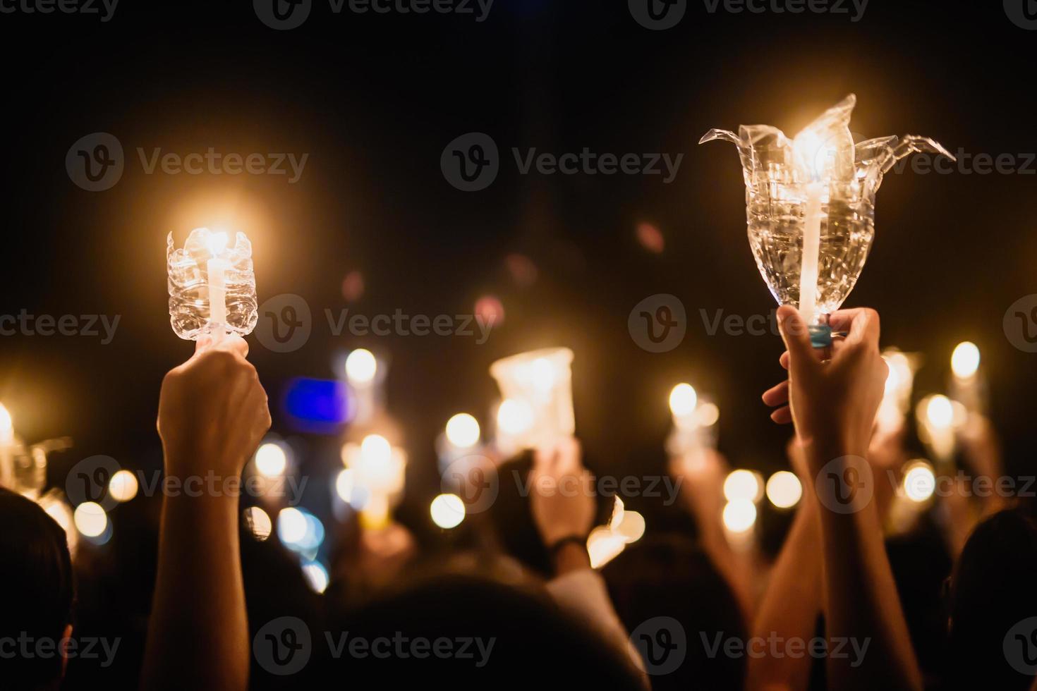 People hands holding candles to pray photo