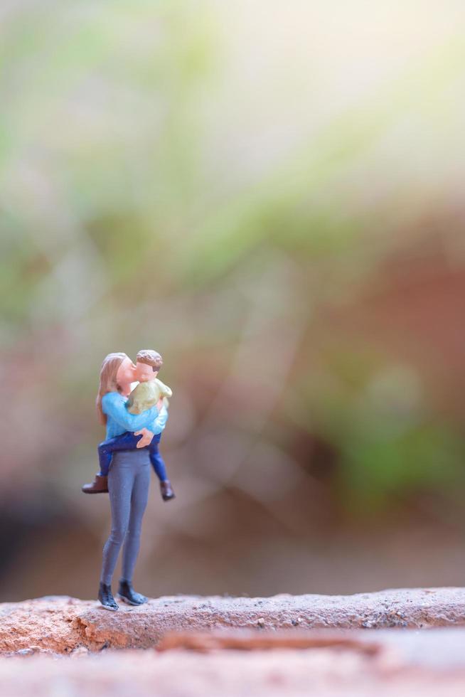 Miniature people, mother holding her cute baby, Happy Mother's Day concept photo