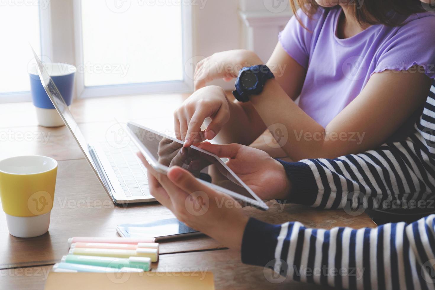 Coronavirus concept. Couples quarantining looking at the same tablet to video call their parents. photo