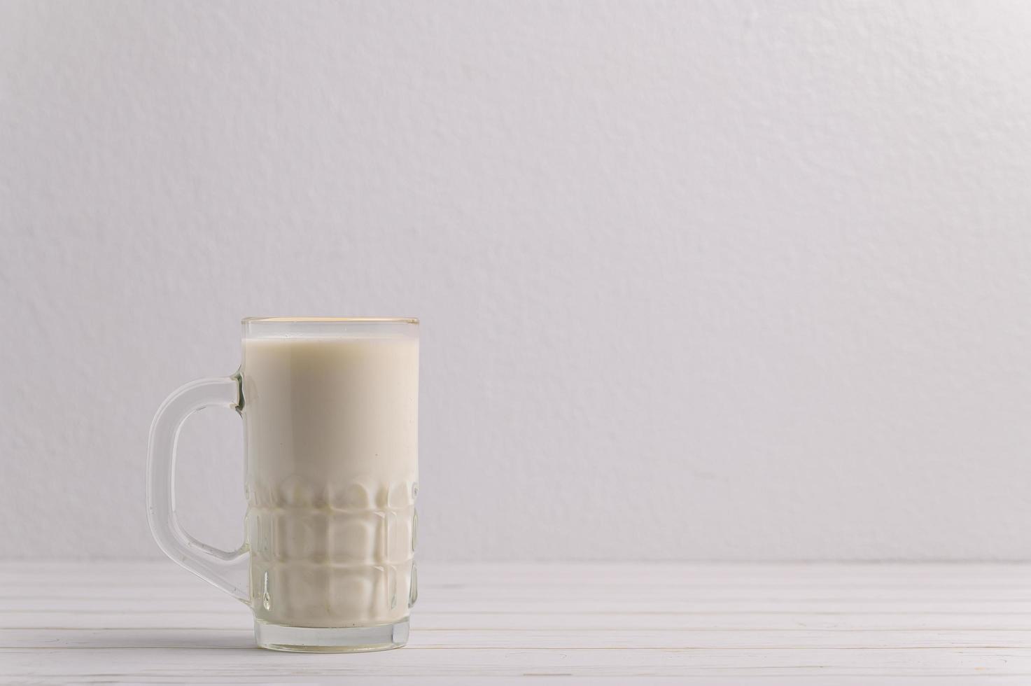 A glass of milk on the desk photo