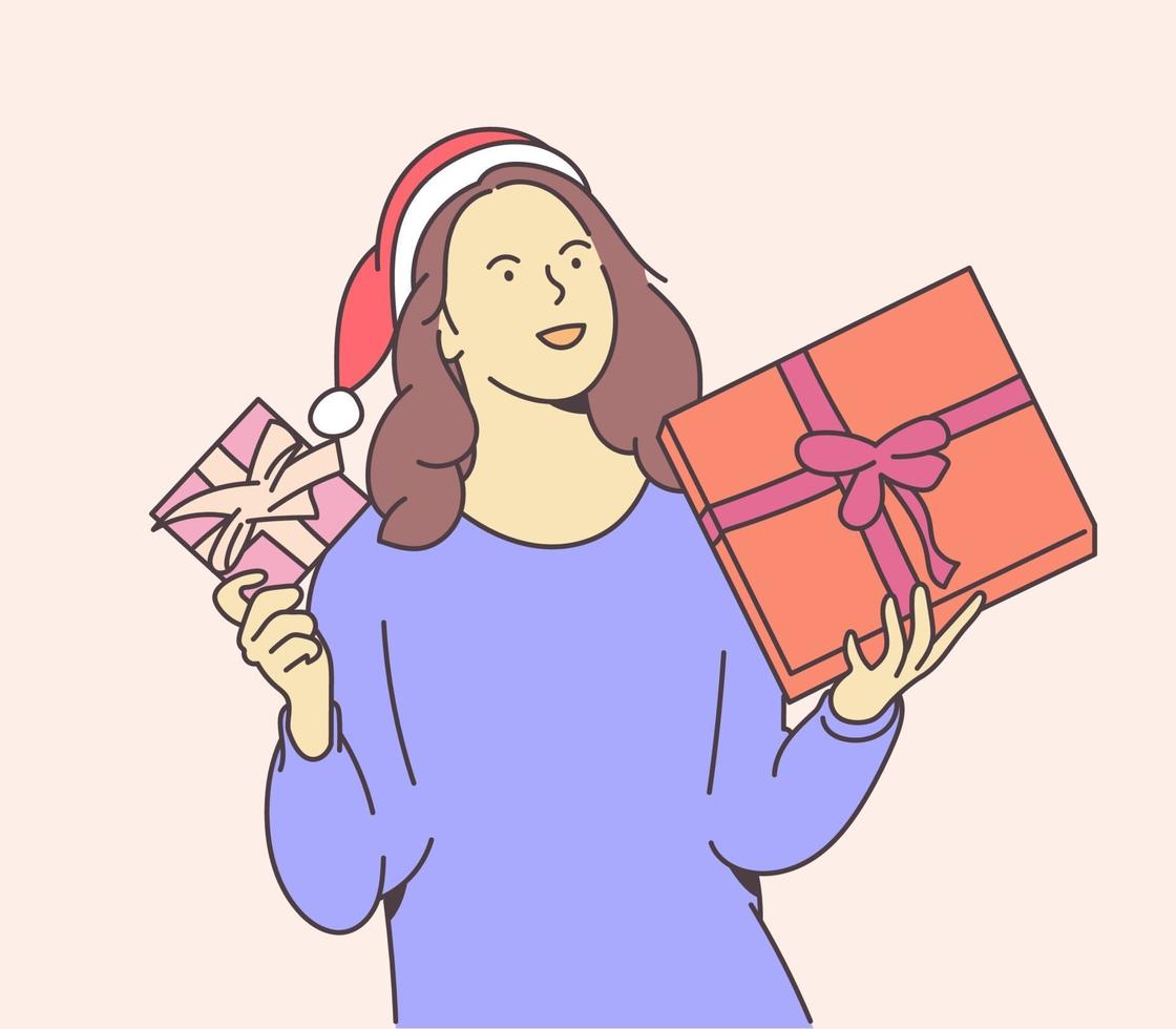 concepto de navidad o año nuevo. joven feliz vestida con gorro de Papá Noel guarda cajas con regalos de Navidad. vector