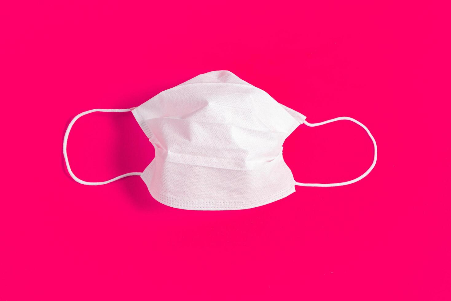 Surgical mask over minimalist pink background 2310730 Stock Photo at