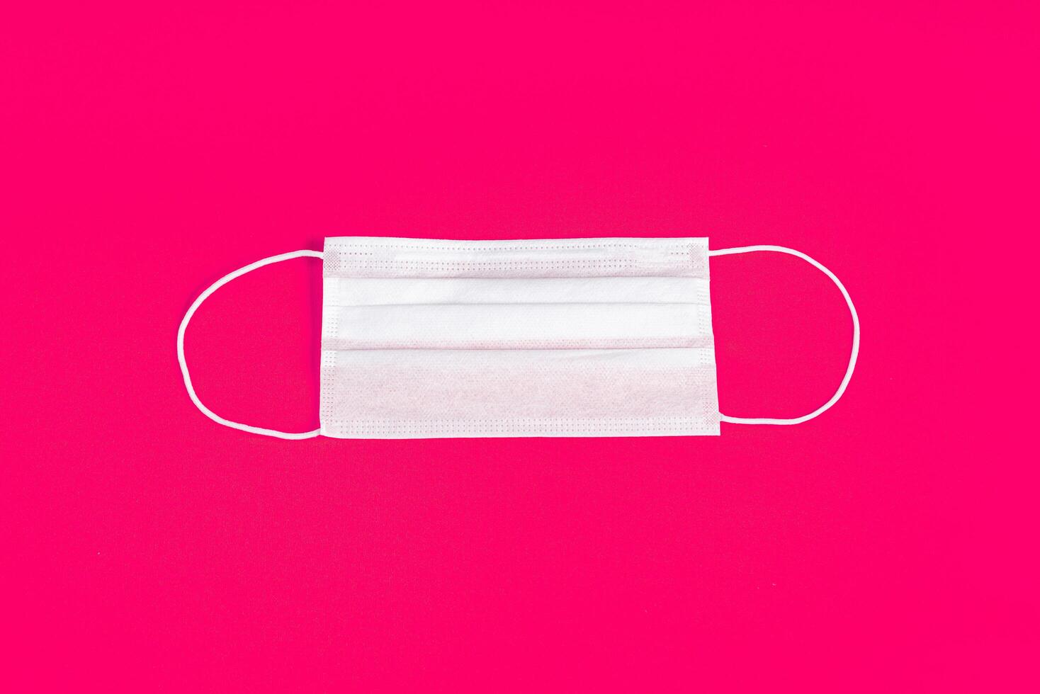 Surgical mask over minimalist pink background 2310750 Stock Photo at